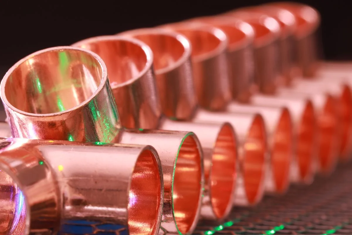 Copper pipe fittings arranged in a row